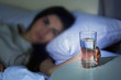 © Africa Studio - Young woman in bed taking glass of water from table at night