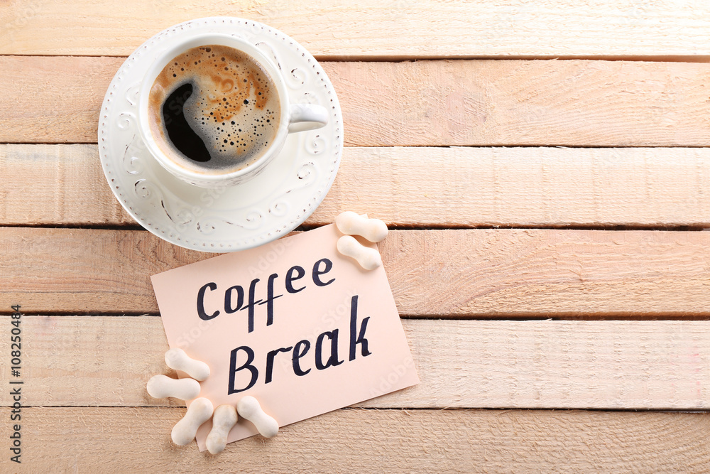 Cup of coffee and note COFFEE BREAK on wooden background