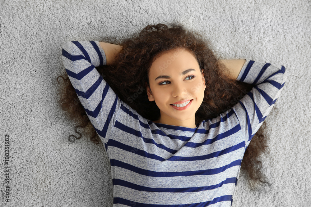 Relaxed young woman lying on the floor