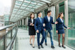 © leungchopan - Group of business people walking at bridge
