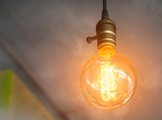 Wall Mural - vintage light bulb glowing in the smoke