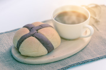 Wall Mural - Bread and hot coffee on wooden coaster.