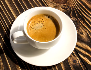 cup of coffee on a wooden old board  