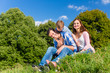 © Kzenon - Family having fun sitting in the green grass