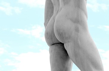 detail of the back of the marble statue with muscular legs