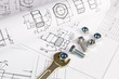 © bayurov - Wrench, bolts and nuts on a background of engineering drawings. Science, mechanics and mechanical engineering.