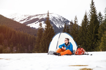 Wall Mural - Hiker in tent on mountainside.