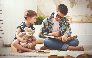 Wall Mural - children brother and sister, boy and girl reading a book