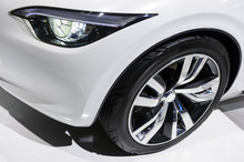 Car Headlight And Wheel With Silver Disk Of Comfortable Sport Sedan With White Bodywork, Luxury Class Vehicle