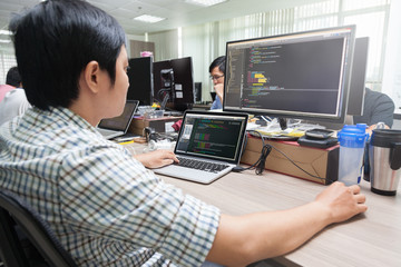 Asian Outsource Software Developer Looking Screen Sitting At Desk