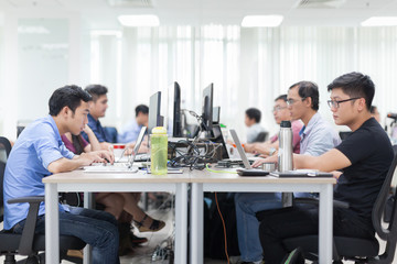 asian businessman sitting at desk working laptop computer busine