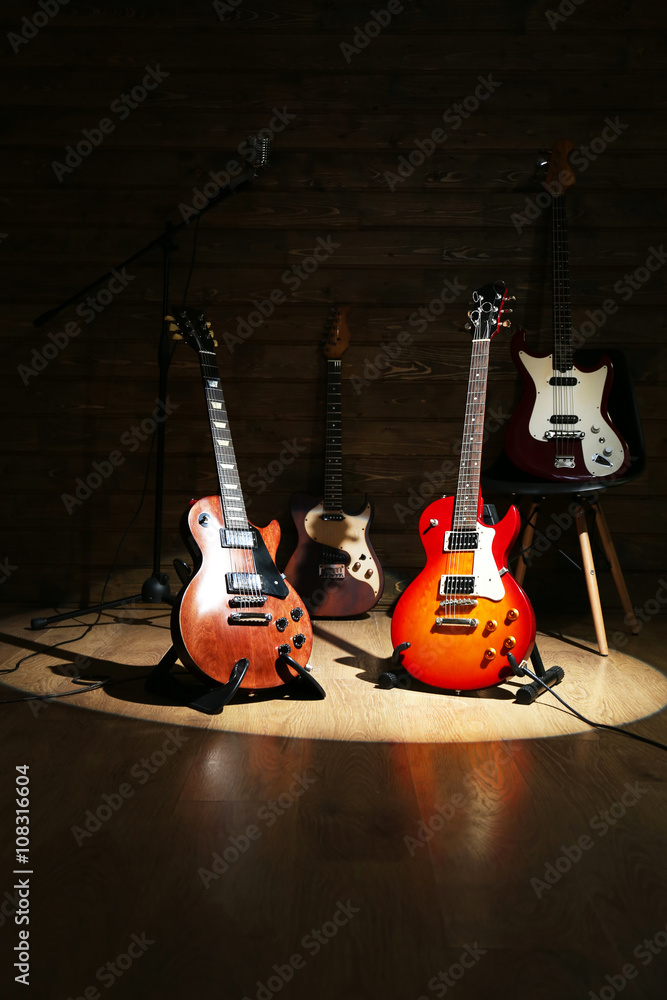 Electric guitars on lighted wooden background