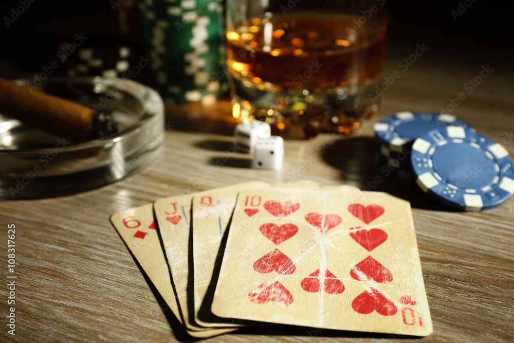 Set to playing poker with cards and chips on wooden background