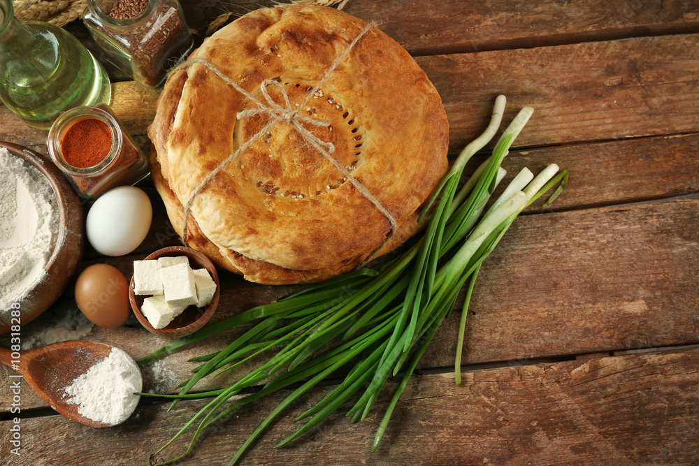 Fresh fried bread with other products on wooden table closeup