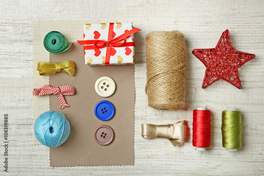 Sewing creative accessories on wooden table, top view