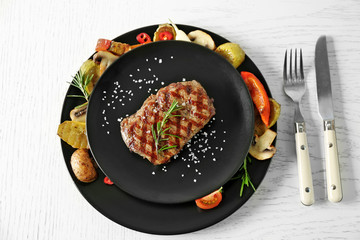 Sticker - Delicious grilled steak with vegetables on plate