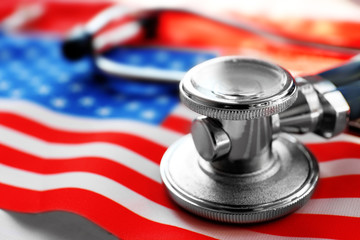 Stethoscope on national flag of USA. American medicine concept