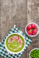 Sticker - Pea cream with radishes on a rustic wooden background
