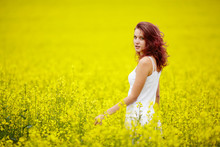 Young Beautiful Girl In Yellow Field