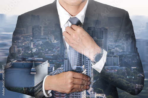Photographie Businessman held necktie dress to look good and city in a foggy morning as Readiness concept