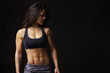 © Guerilla - Dark haired woman in sports clothing looking down, portrait