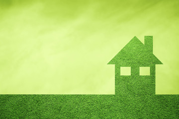 Eco green house concept copy space background with grass texture. Friendly living in eco green modern home.