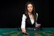 © nazarovsergey - The beautiful girl, dealer, behind a table for poker