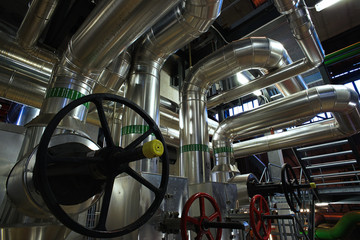 Equipment, cables and piping as found inside of a modern industr