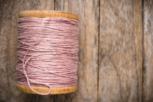 Reel Pink Yarn Left Side On Wood