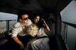 Happy beautiful newlyweds in the helicopter