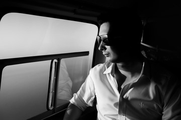 Happy beautiful groom in the helicopter b&w