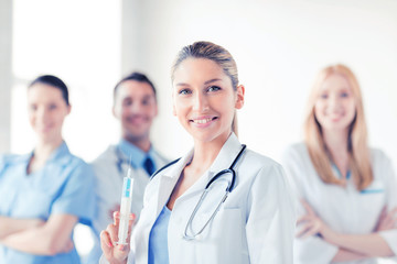 Canvas Print - female doctor holding syringe with injection