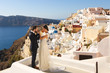 bride and groom posing in Santorini