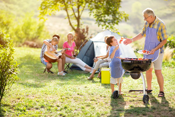 Wall Mural - grandfather and grandson making barbecue .