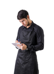 Wall Mural - Young chef or waiter wearing black apron isolated