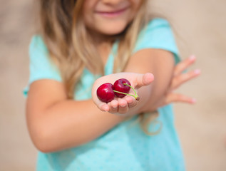 Cherries in child's hand