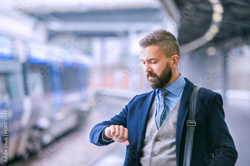 Fotografie, Obraz Close up, hipster businessman waiting at the train station
