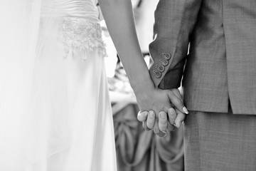 Bride and groom holding hands