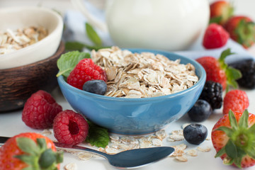 Wall Mural - Rolled oats in a bowl with berries  and milk