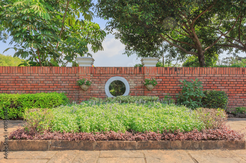 A Garden Decoration With A Brick Wall Background Buy This Stock