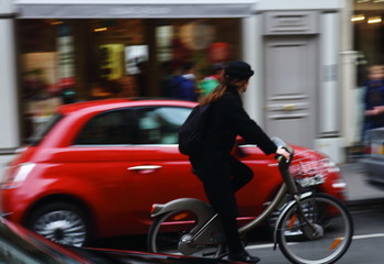 Red fiat 500 car and bicycle in Paris 