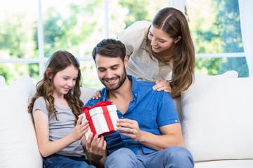 Wall Mural - Family looking at gift 