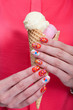 Girl holding ice cream in hands. Hands with beautiful colored manicure closeup