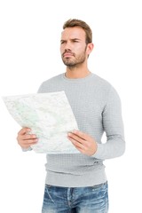 Wall Mural - Young serious man holding a map