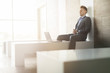 © Andriy Bezuglov - Business man sitting alone on a bench with laptop