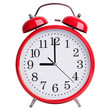 Round alarm clock shows exactly nine o'clock