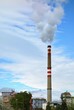 large factory chimney smokes and blue sky