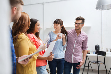 Canvas Print - creative team on coffee break talking at office