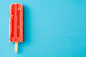 Strawberry popsicle on blue background
