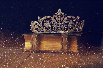 Sticker - low key image of beautiful diamond queen crown on old book